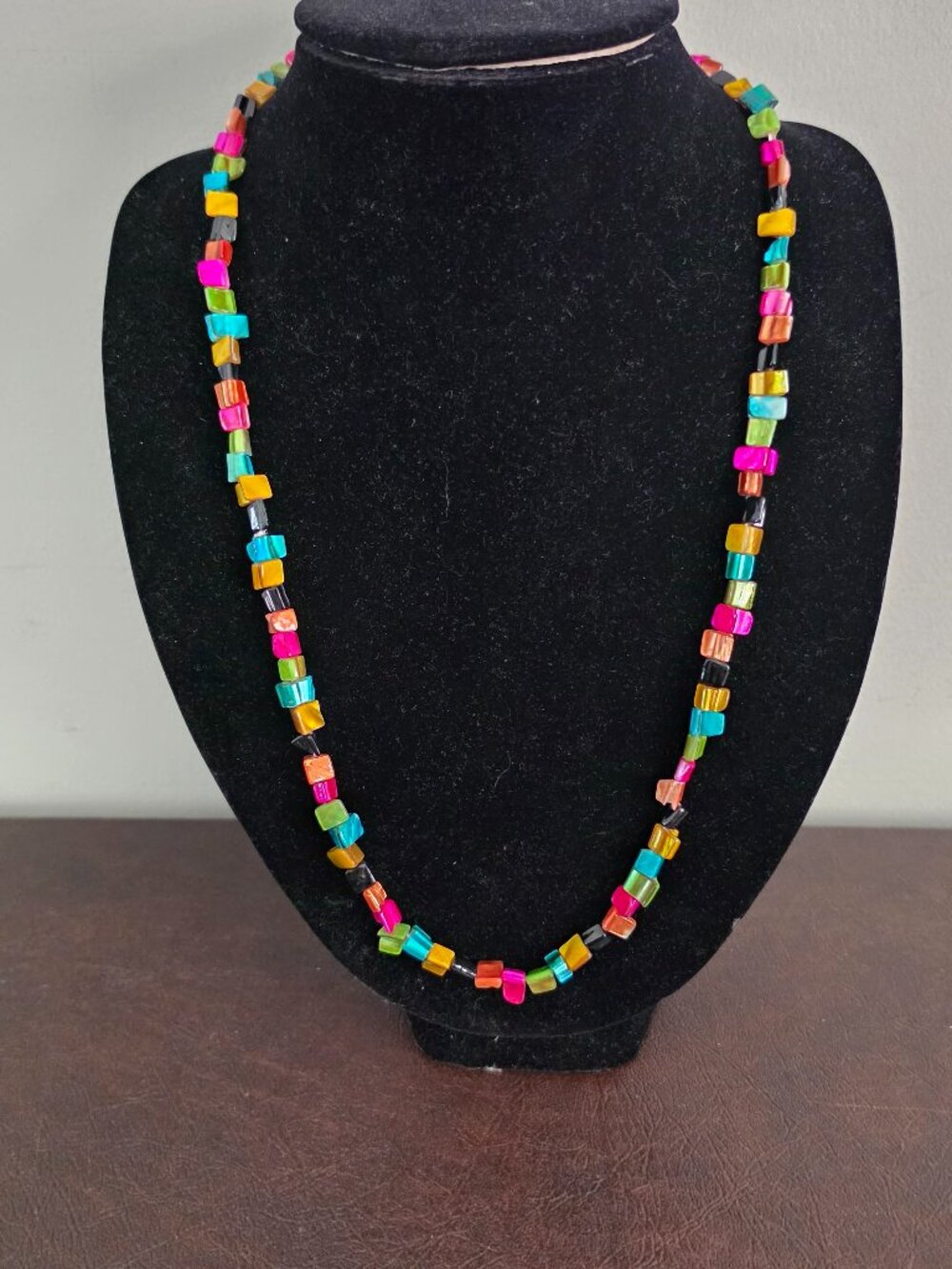 Necklace features a colorful rainbow design created with multi-strands